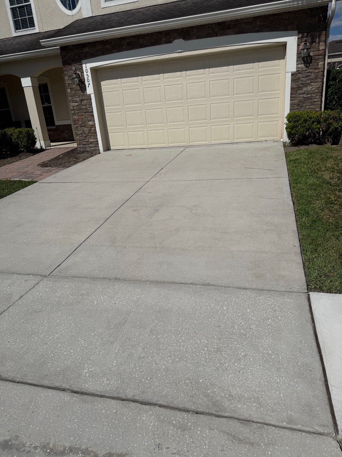 After: the same driveway and walkway cleaned by Pure Pressure