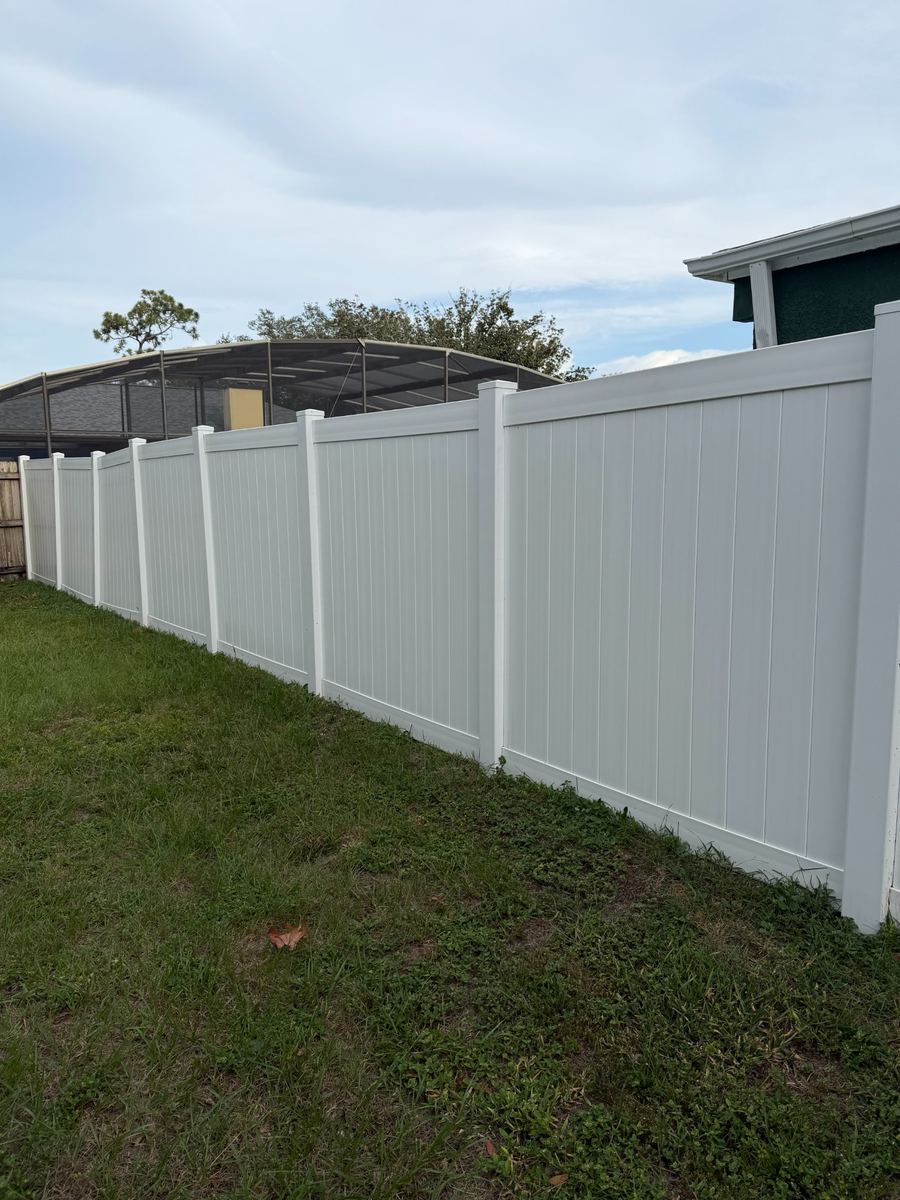 After: the same white vinyl privacy fence cleaned to a bright, even finish
